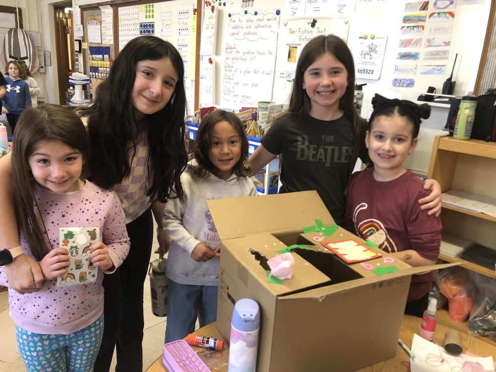 5th and 1st grade students making Leprechaun traps