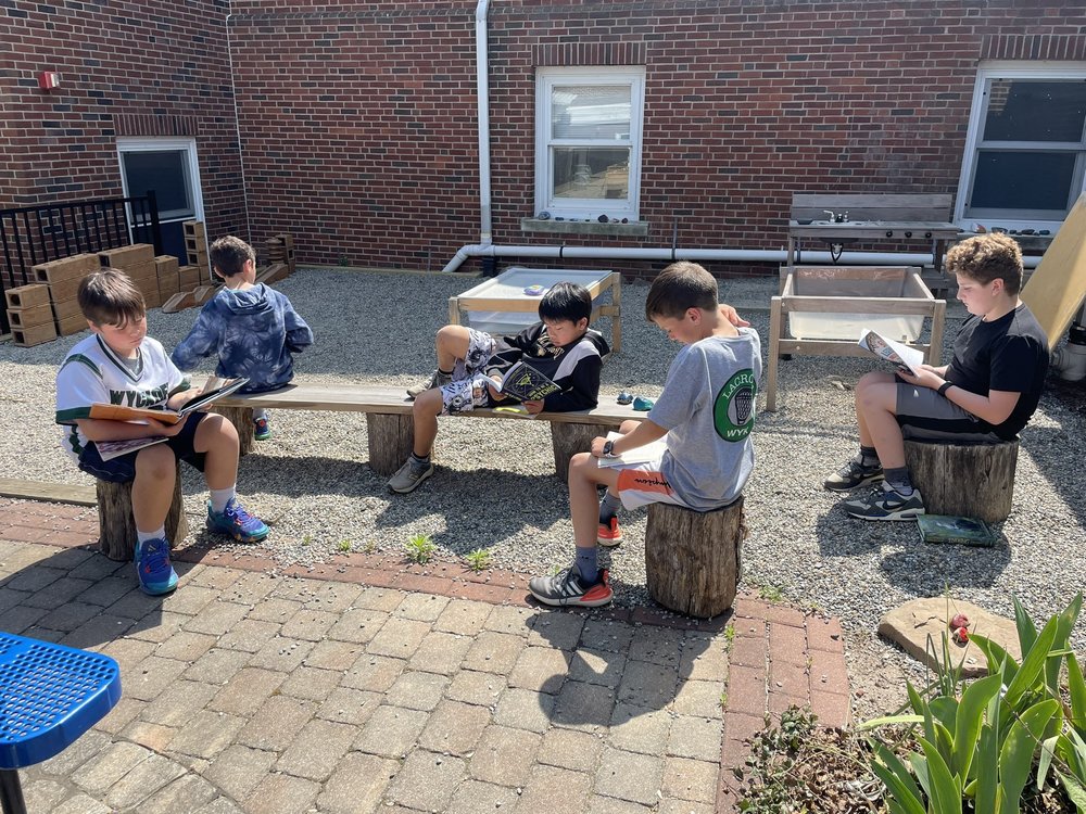 students reading in the outdoor courtyard