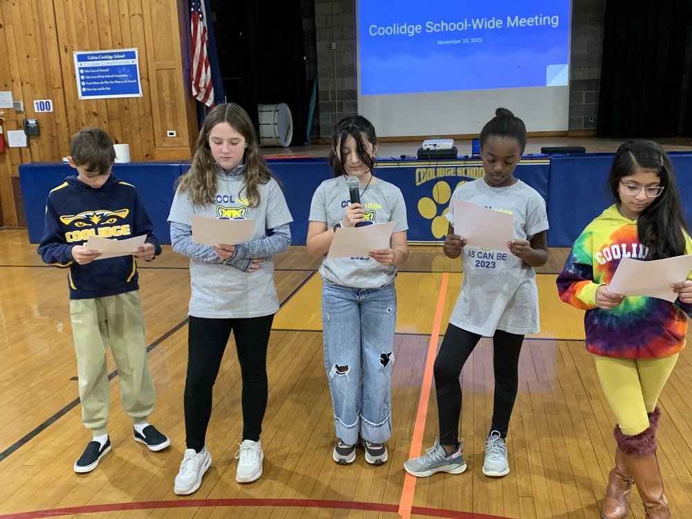 Student Council members presenting at schoolwide meeting