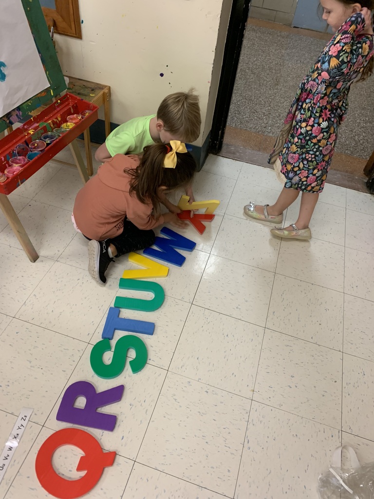 children laying out abc letters