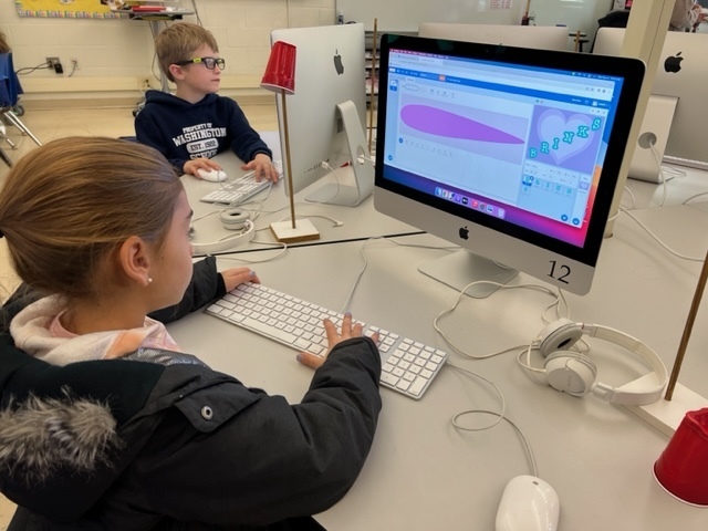 Student coding letters to move using Scratch