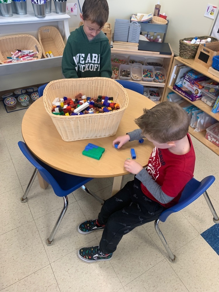 boy arranging unifix cubes