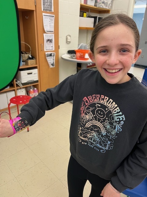 One student showing the wrist bracelet she made using duct tape and a Micro:Bit to count her steps.